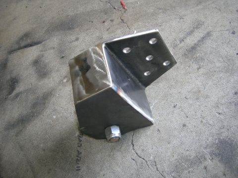 1996 Ford Bronco - A custom metal bracket with a bolt is shown on a concrete surface.