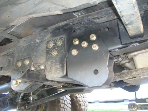 1996 Ford Bronco - Close-up view of a custom radius arm mount modification on a vehicle's undercarriage.
