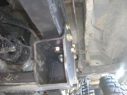 1996 Ford Bronco - Custom radius arm mount installation on a vehicle's frame, showing bolted bracketry and suspension components.