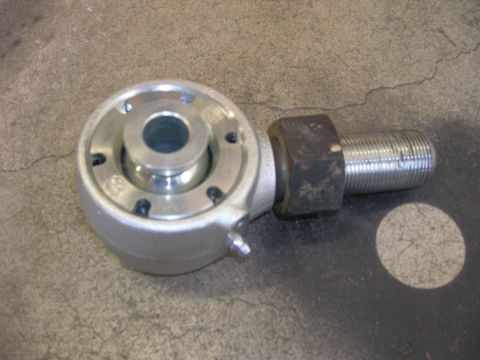 1996 Ford Bronco - A close-up view of a metal suspension joint with a threaded bolt and hex nut.