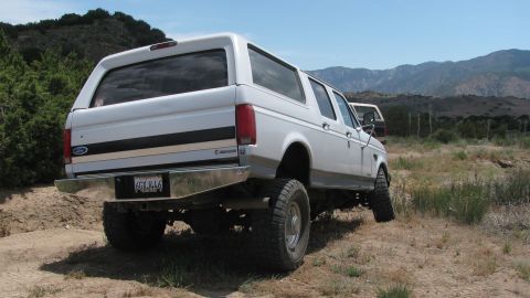 1996 Ford C-350 (Centurion Conversions) - This 1996 Ford C-350 Centurion Conversions is seen from the rear in an off-roading setting.