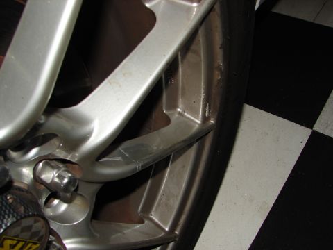 1992 Ford Taurus - A close-up view of a car's wheel and tire, set against a distinctive checkered floor pattern.