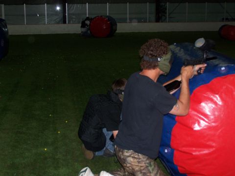 1986 Ford Bronco - Players take cover behind inflatable barriers during an indoor paintball game.
