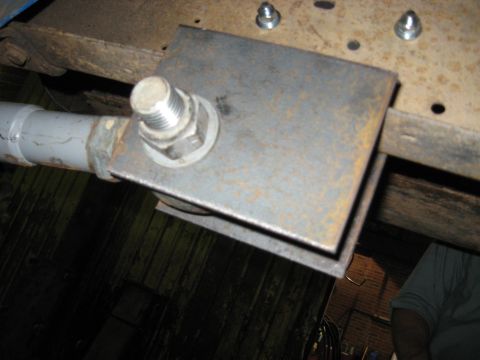 1978 Ford Bronco - Custom bracket and pipe assembly mounted to the underside of a vehicle frame.
