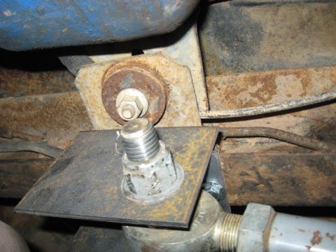 1978 Ford Bronco - This image shows a close-up of a vehicle's suspension component, rusty metal and a large bolt assembly.
