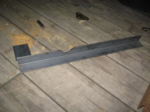 1978 Ford Bronco - A metal bracket is shown on a weathered wooden deck, with tools visible in the background.