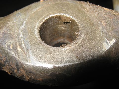 1978 Ford Bronco - A close-up view of a heavily worn metal component, showing significant rust and damage around its central opening.