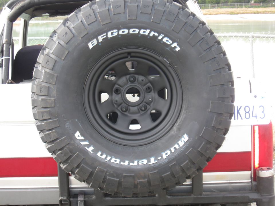 BFGoodrich Mud-Terrain T/A tire mounted on rear carrier of a vehicle. License plate visible