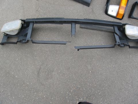 1986 Ford Bronco - Front grille support assembly with headlights, likely for a truck or SUV.