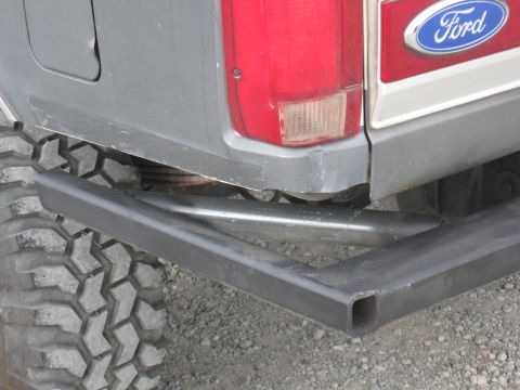 1991 Ford Bronco - Rear view of a gray 1991 Ford Bronco with a custom bumper and off-road tire.