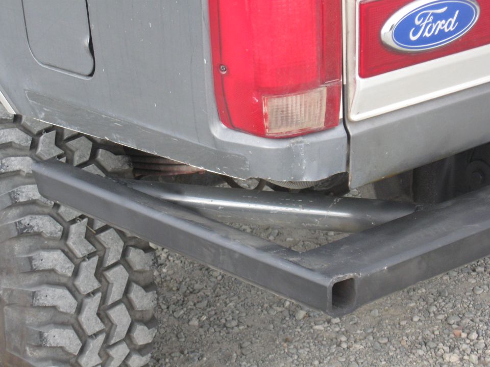 Gray 1991 Ford Bronco rear bumper and large off-road tire