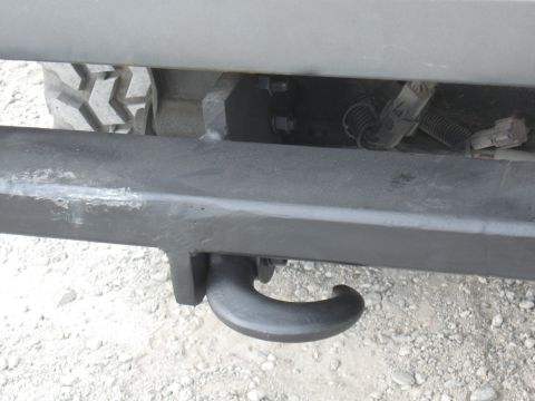 1991 Ford Bronco - Close-up view of a tow hook attached to a vehicle's bumper, with a tire visible in the background.
