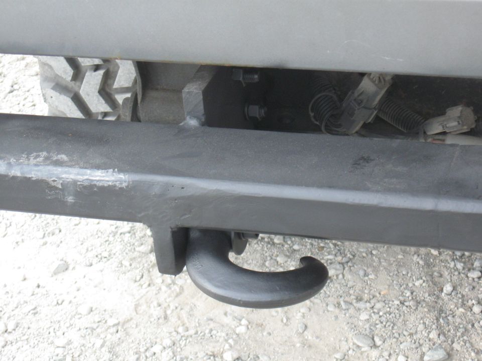 Tow hook on vehicle bumper with tire visible