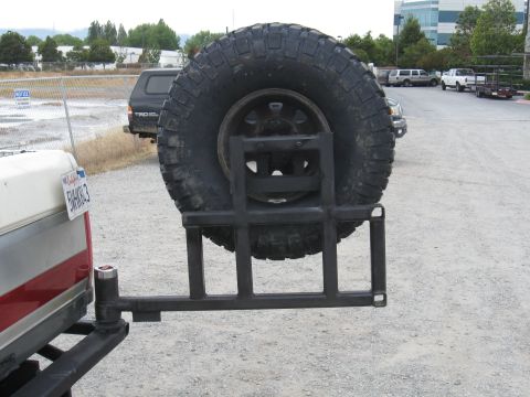 1991 Ford Bronco - Aftermarket spare tire carrier mounted to the rear of a pickup truck.