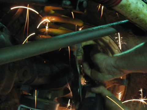 1978 Ford Bronco - Sparks fly during automotive suspension work, obscuring details of the vehicle.