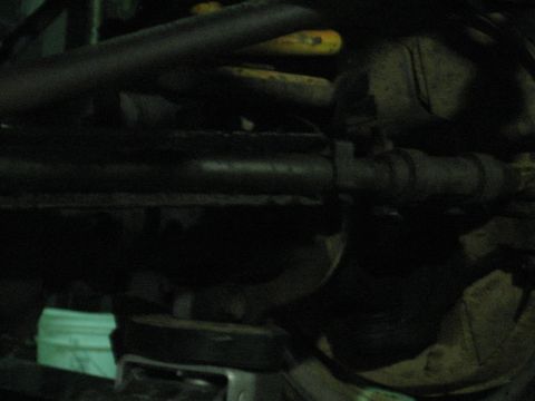 1978 Ford Bronco - Close-up view of a vehicle's undercarriage, showing mechanical components and suspension elements.