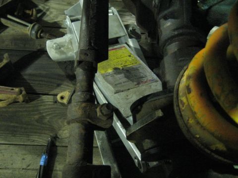 1978 Ford Bronco - Car jack and rusty suspension parts are visible in this close-up shot.