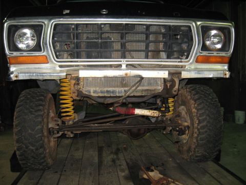 1978 Ford Bronco - Front view of a 1978 Ford Bronco, highlighting its grille and suspension system with prominent yellow coil springs.