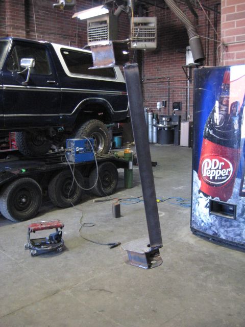 1978 Ford Bronco - A 1978 Ford Bronco is seen on a trailer in a workshop, next to a Dr. Pepper vending machine.
