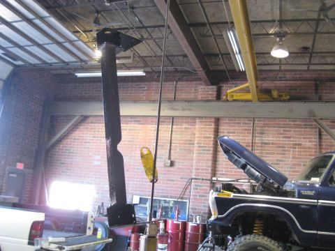 1978 Ford Bronco - A 1978 Ford Bronco is in a garage with its hood up, beside a white pickup truck.