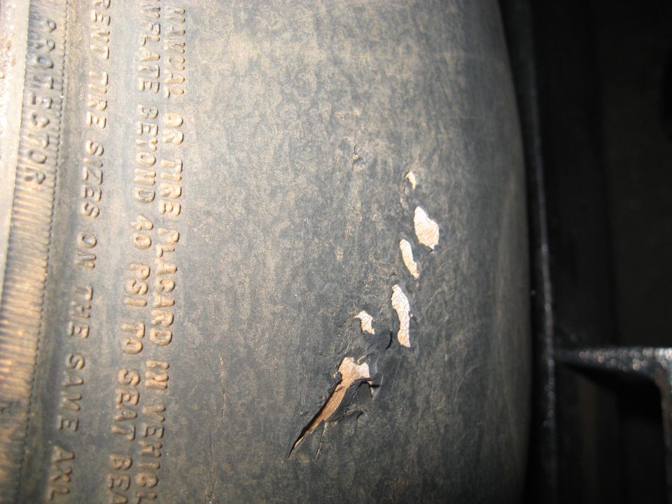 Tire sidewall with text and damage
