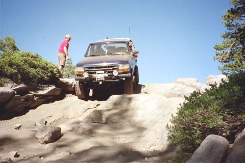 1994 Ford Bronco - This 1994 Ford Bronco tackles a challenging rocky path, demonstrating its off-road capabilities.
