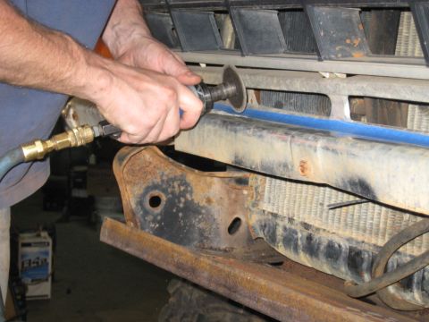 1978 Ford Bronco - Vehicle front end being worked on with an angle grinder.