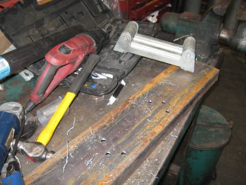 1978 Ford Bronco - Tools and metal parts on a workbench, ready for fabrication or repair.