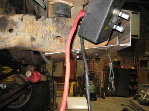 1978 Ford Bronco - Close-up of a winch mounting bracket and associated wiring on a vehicle frame.
