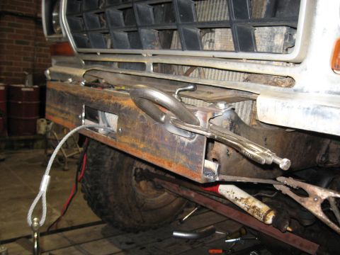 1978 Ford Bronco - A custom bumper is being fabricated and attached to the front of a 1978 Ford Bronco, with welding equipment nearby.