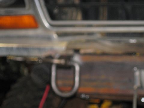 1978 Ford Bronco - Front view of a 1978 Ford Bronco, showing the bumper, tow hook, and turn signal light.