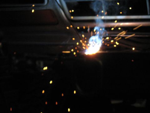 1978 Ford Bronco - Welding sparks illuminate the darkness, suggesting repair or fabrication work.