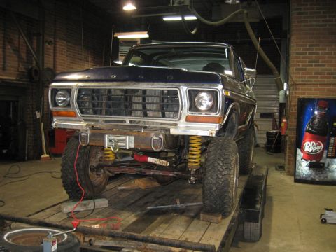 1978 Ford Bronco - Front view of a 1978 Ford Bronco on a trailer, showing its grille and suspension.