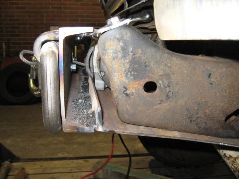1978 Ford Bronco - Detail of a vehicle's frame, showing a winch and tow hook assembly.