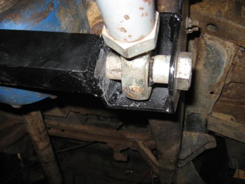 1978 Ford Bronco - The underside of a vehicle reveals its suspension system and frame, with visible signs of rust and wear.