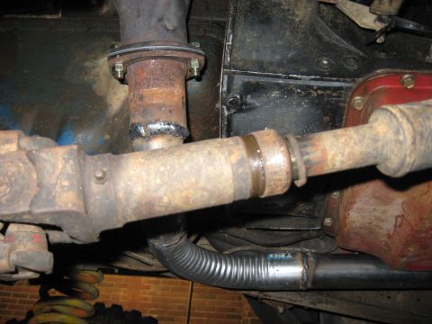 1978 Ford Bronco - Close-up view of the undercarriage, showing the exhaust system and driveshaft components, including a flexible exhaust connector.