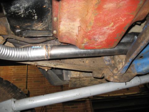 1978 Ford Bronco - A close-up view of the undercarriage reveals a custom exhaust pipe installation with visible welding marks.