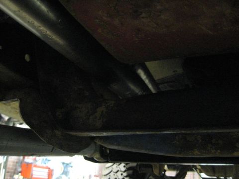1978 Ford Bronco - A close-up shot of the undercarriage reveals some stamped numbers on a metal pipe.
