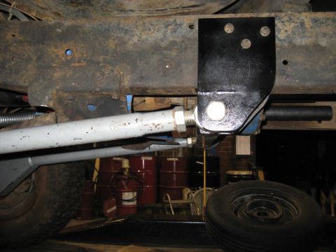 1978 Ford Bronco - Undercarriage view of a vehicle's frame and suspension system, with a spare tire in the foreground.