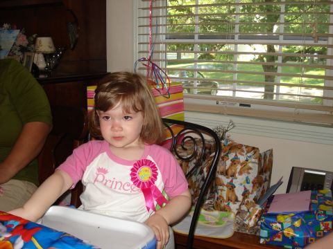 2000 Ford Crown Victoria - A young girl celebrates her birthday surrounded by gifts and party decorations.