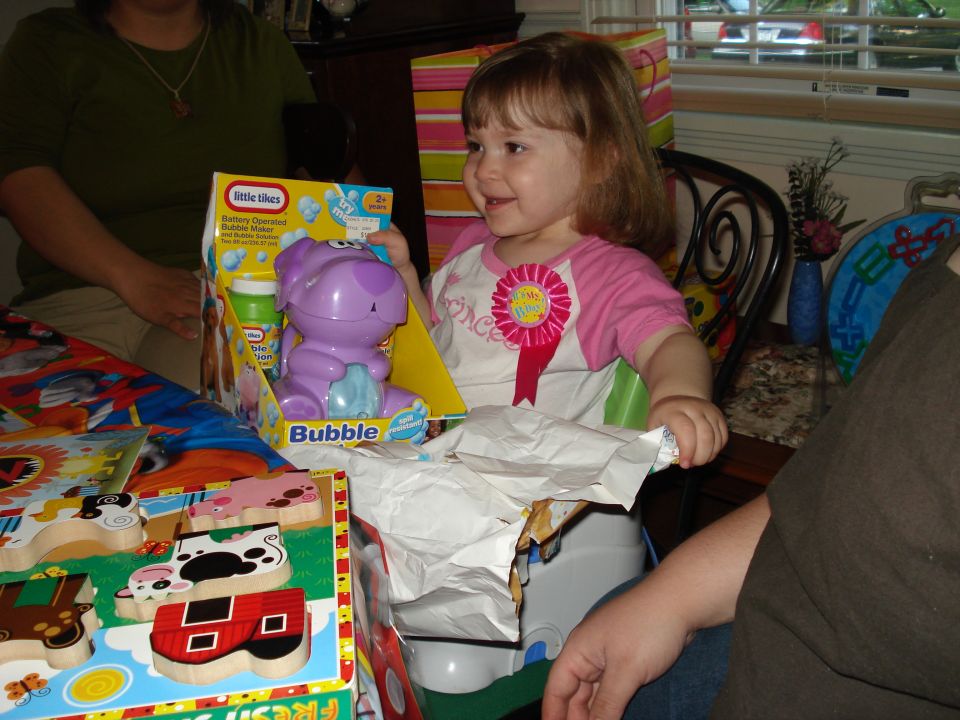 Child opening a bubble maker toy at a birthday party