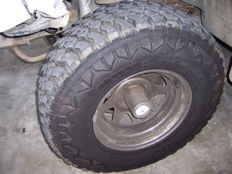 1991 Ford Bronco - Close-up of a vehicle's tire and wheel, showing the tread and rim details.