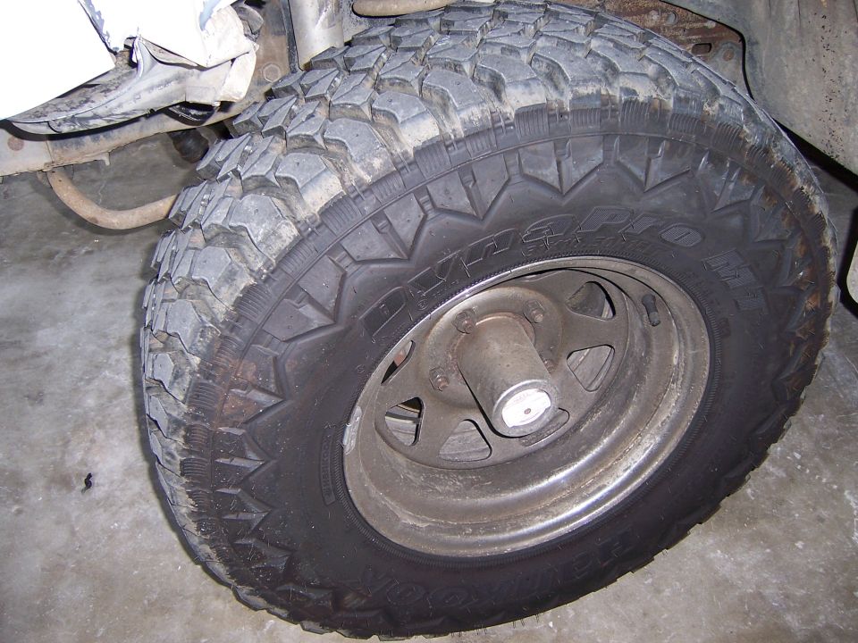 Tire and wheel assembly with aggressive tread pattern and silver rim