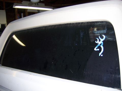 1991 Ford Bronco - Close-up of a white vehicle's rear window a Browning deer logo sticker.