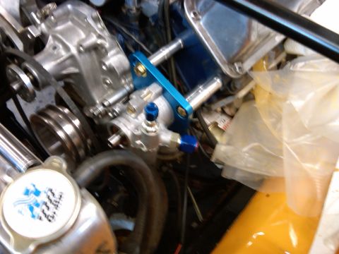 1978 Ford Mustang II - A close-up view of a vehicle's engine bay focuses on the power steering pump assembly and associated plumbing.