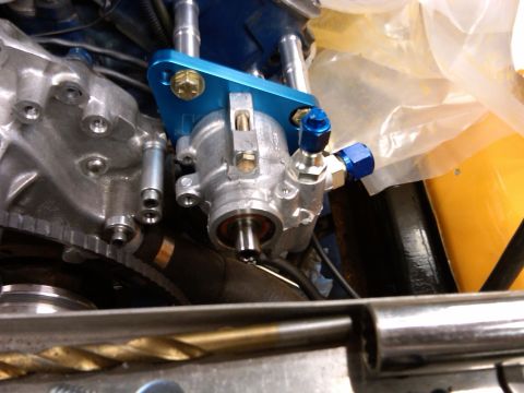 1978 Ford Mustang II - Close-up view of a power steering pump assembly with a blue bracket and fittings.