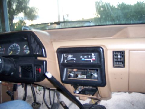 1991 Ford Bronco - The interior of a vehicle shows the dashboard with various controls and vents.
