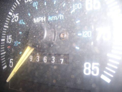 1991 Ford Bronco - The odometer shows 93,637 miles on this dusty dashboard.