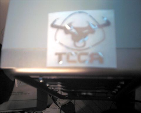 1990 Ford Taurus - A close-up of a TLCA logo bull horns and text is visible.