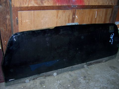 1991 Ford Bronco - A black glass panel, possibly a vehicle window, is shown with a Browning logo on its surface.